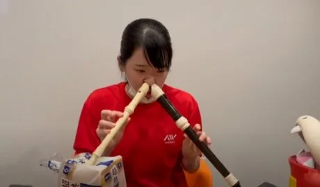japanese women playing recorder with nose