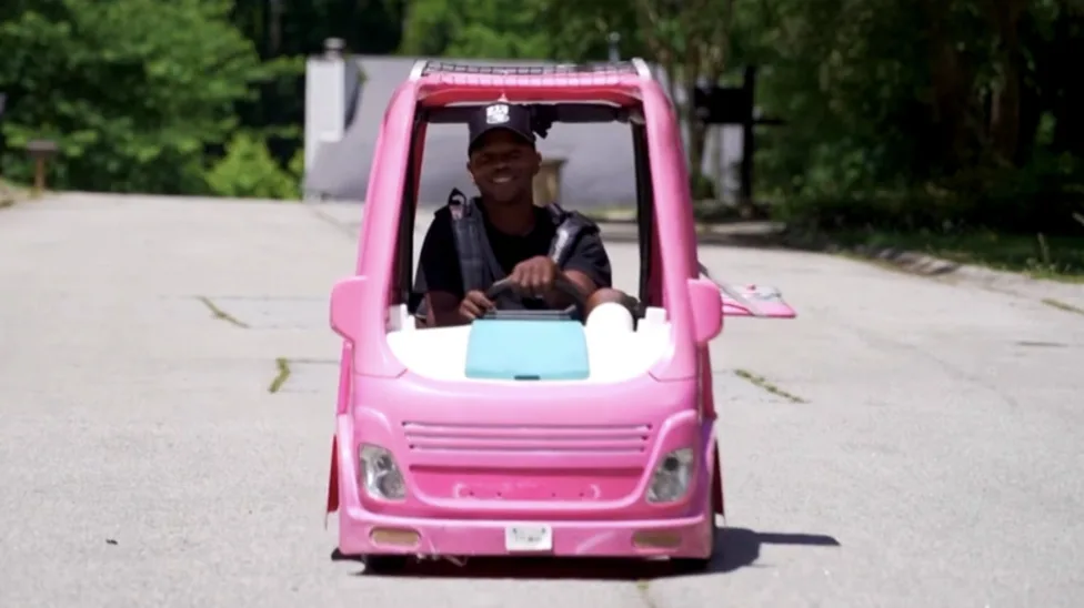 Mali Hightower driving his barbie toy car jeep